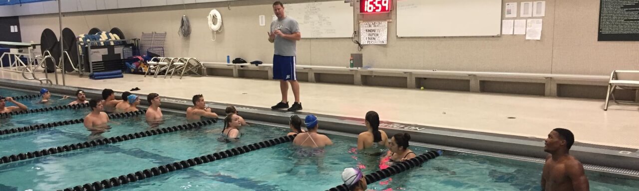 Students in a pool getting instruction